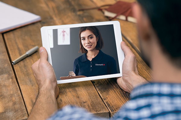 Overlooking a person holding a tablet with their Lifemark therapist